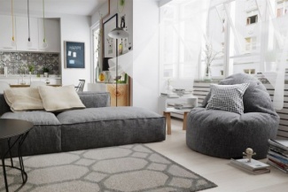 Aqui, ladrilho hidráulico na cozinha integrada com a sala combina com a sobriedade do sofá cinza;