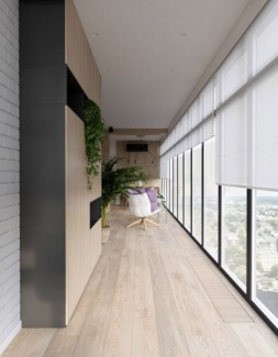 Esse mesmo padrão de tons naturais segue no corredor, bem como mobiliário planejado para armazenamento com plantas.