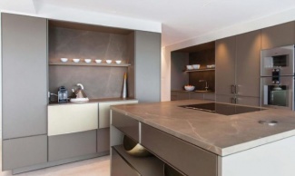 Cozinha branca e armários planejados em greige, para combinar com o granito na ilha.